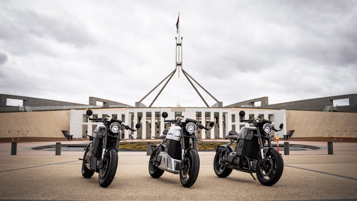 Three Savic C-Series electric motorcycles outside Parliament House in Canberra