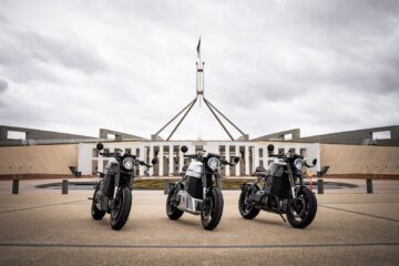 Three Savic C-Series electric motorcycles outside Parliament House in Canberra