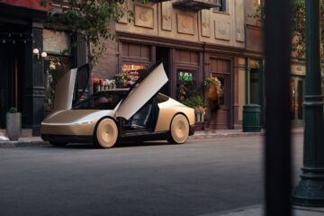 Tesla Cybercab with its dihedral doors open on a city street