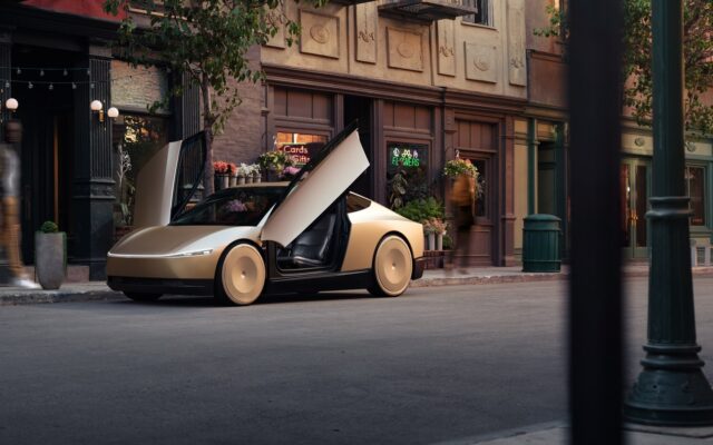 Tesla Cybercab with its dihedral doors open on a city street
