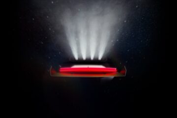 Tesla Roadster teaser image showing the rear of the car upside down with four thruster plumes against a starfield