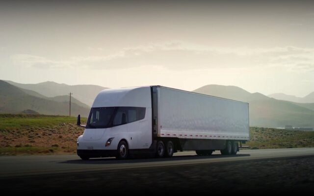 Tesla Semi with trailer driving on a highway