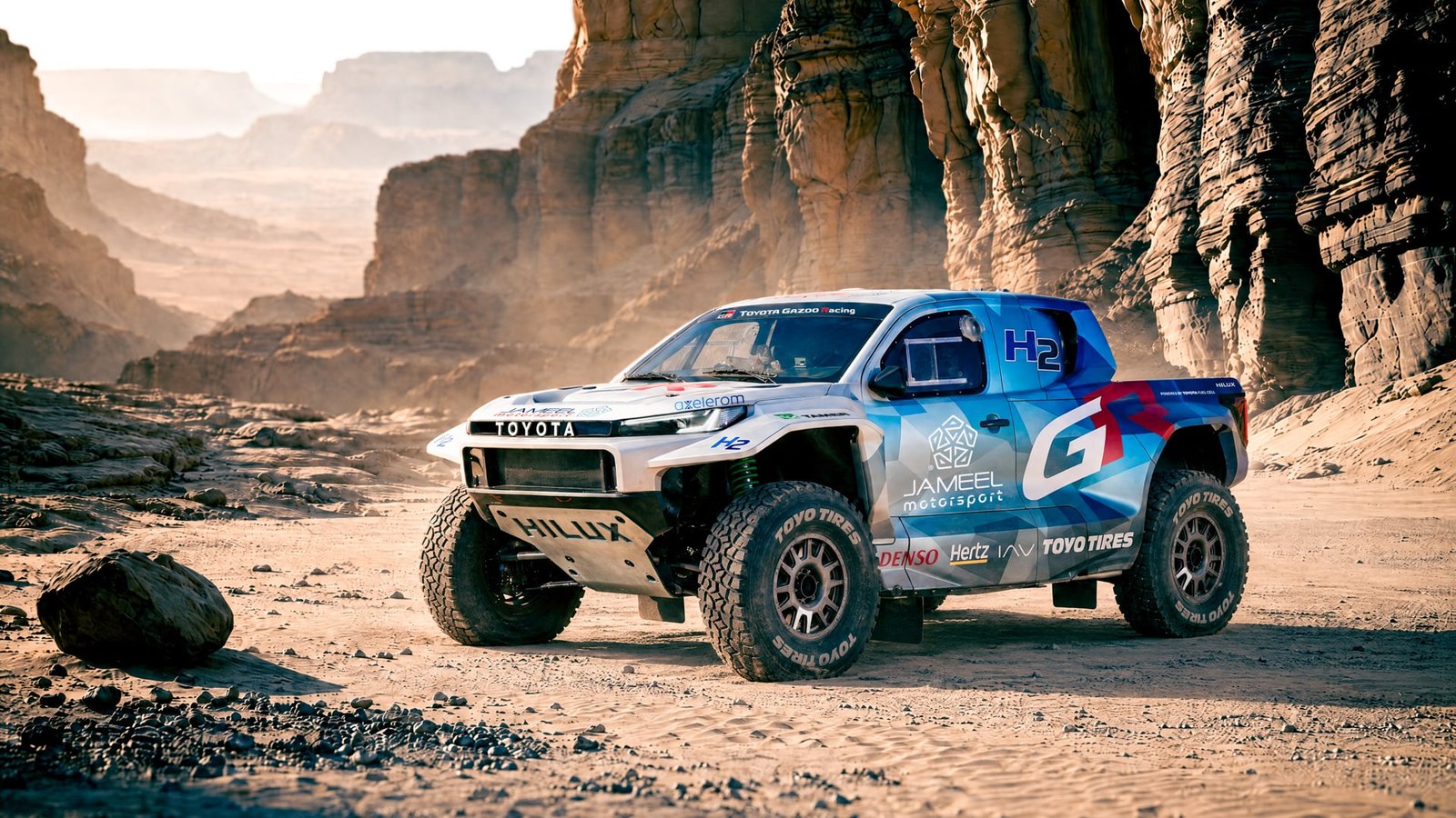 Toyota DKR GR FC Hilux front three quarter in a rocky desert
