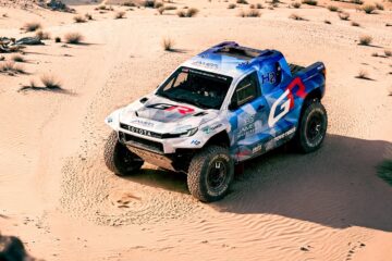 Toyota DKR GR FC Hilux hydrogen rally truck driving through sand dunes