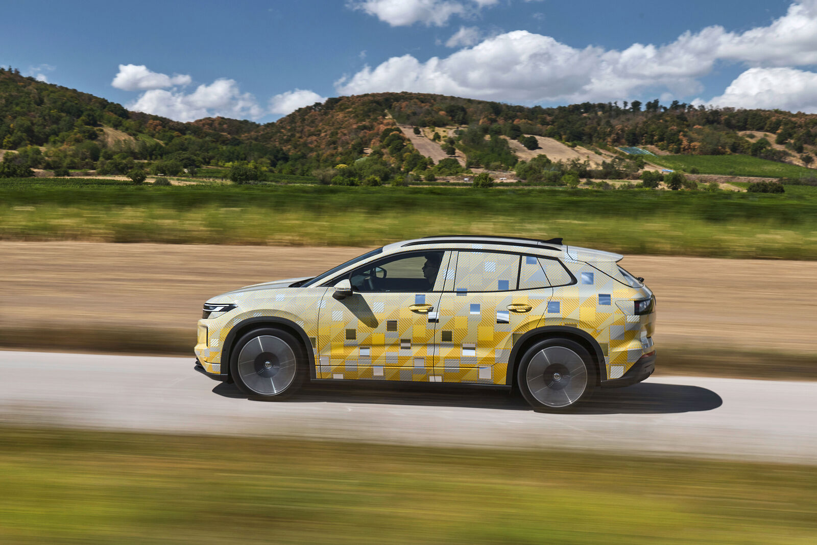 Side view of a camouflaged Volkswagen ID. Tiguan prototype on the move