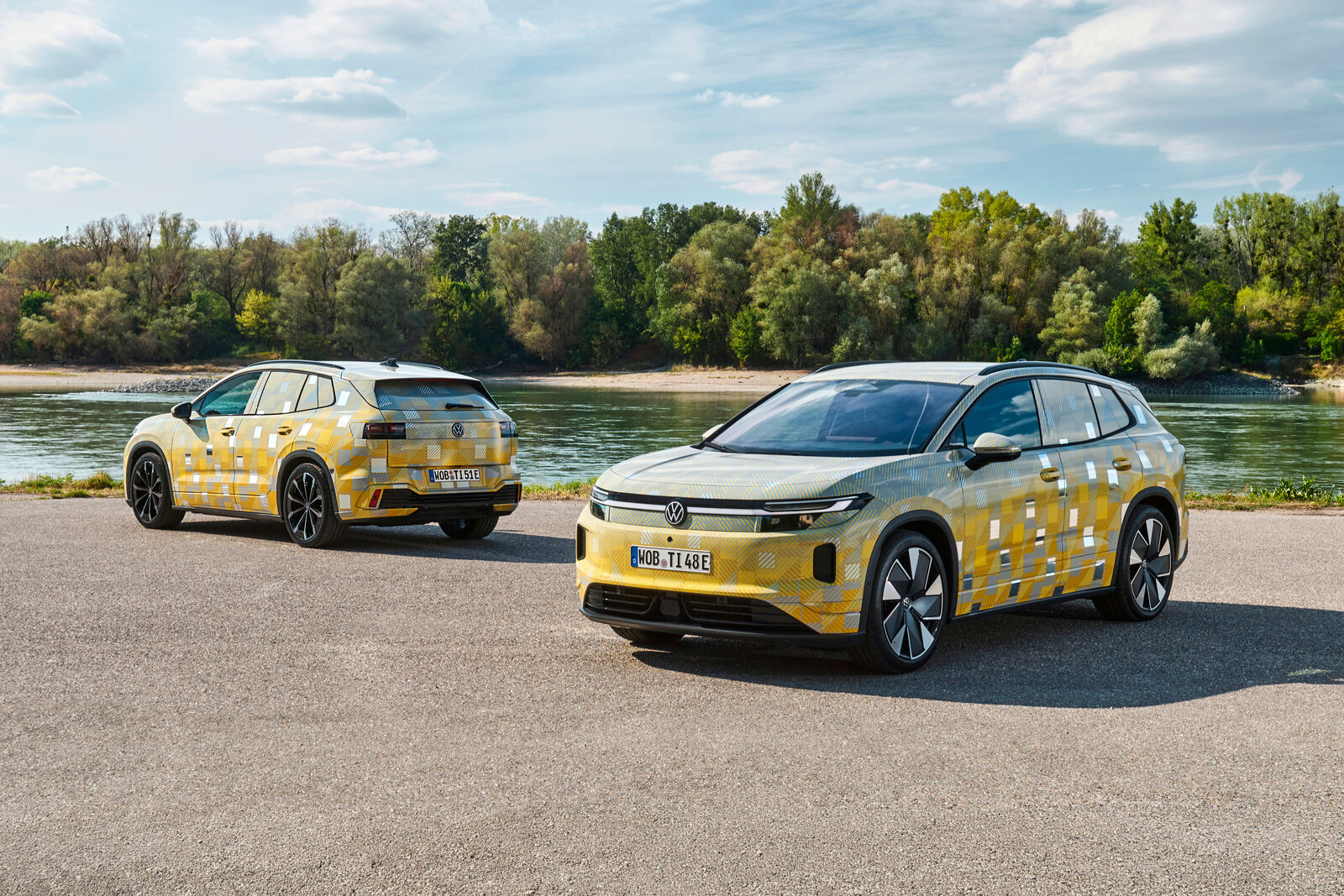 Camouflaged Volkswagen ID. Tiguan prototypes parked by the water