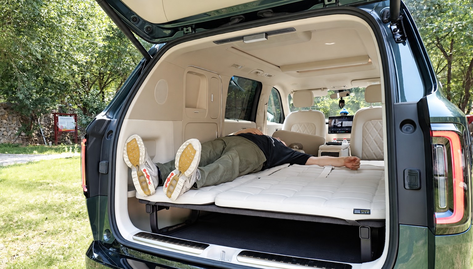Skynomad N90 Studio with the second row folded into a bed, seen from the open tailgate