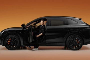 Black Zeekr 7X side profile with a man seated in the open driver's door