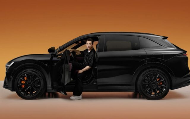 Black Zeekr 7X side profile with a man seated in the open driver's door