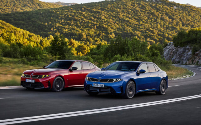 Blue BMW i3 and red BMW 3 Series sedans on a mountain road
