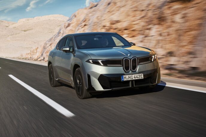 BMW iX4 front view driving
