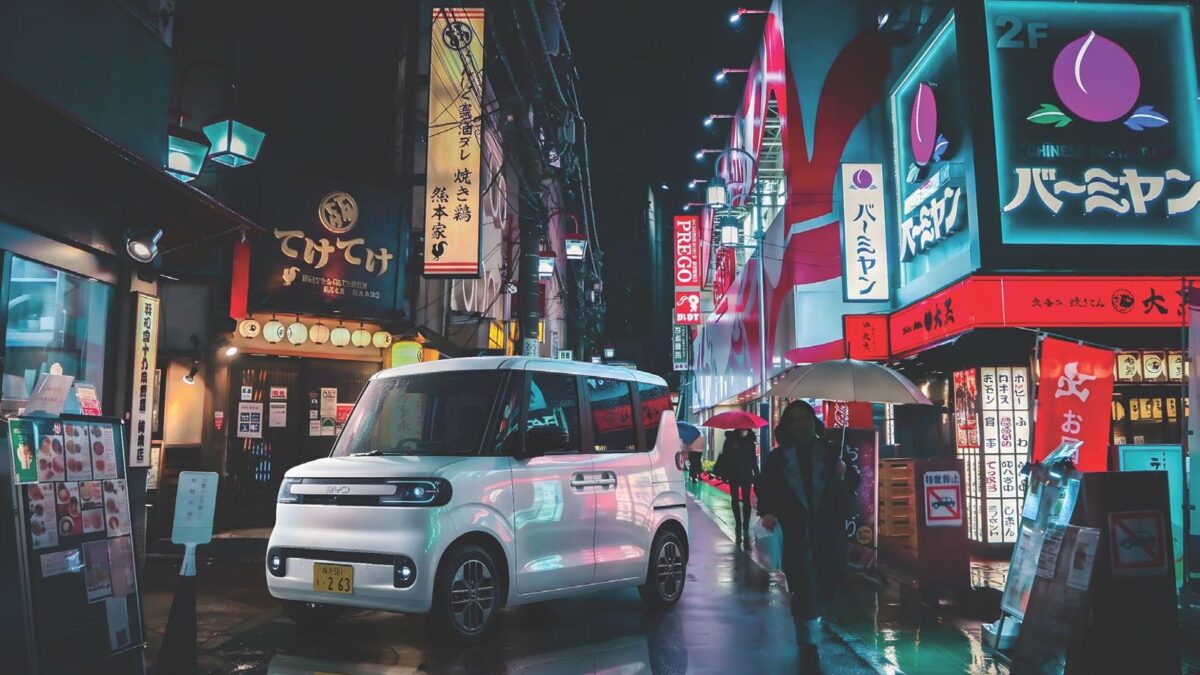 White BYD Racco on a wet Tokyo street at night