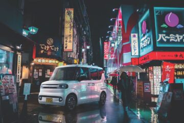 White BYD Racco on a wet Tokyo street at night