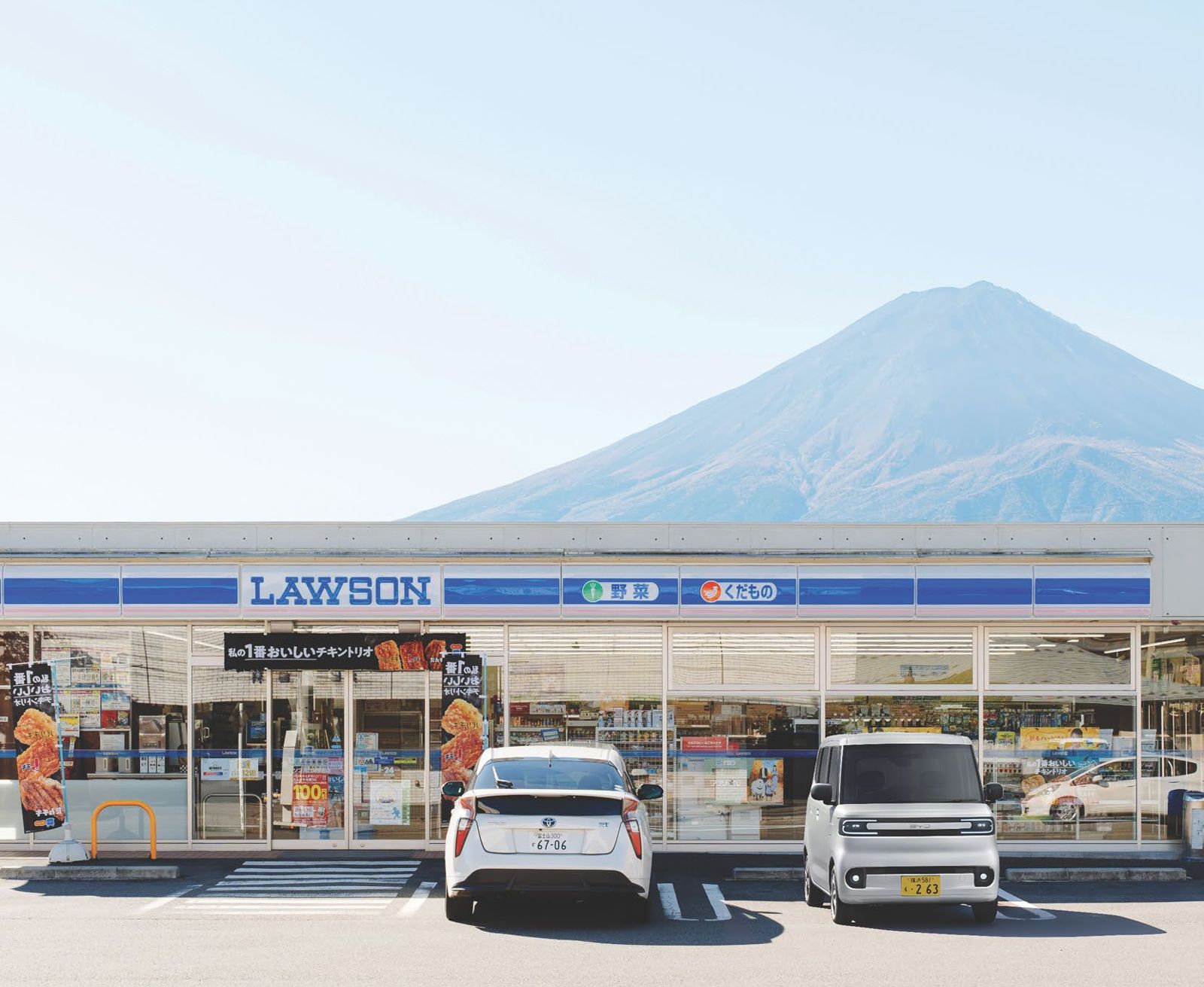 BYD Racco parked at a Lawson convenience store with Mt Fuji behind