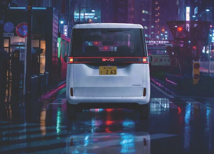 BYD Racco from behind on a wet street at night