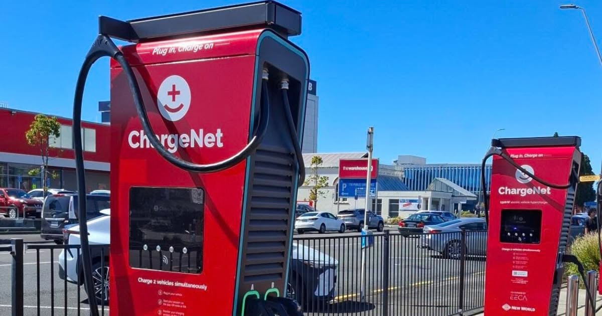 Two red ChargeNet hyperchargers at a New World car park