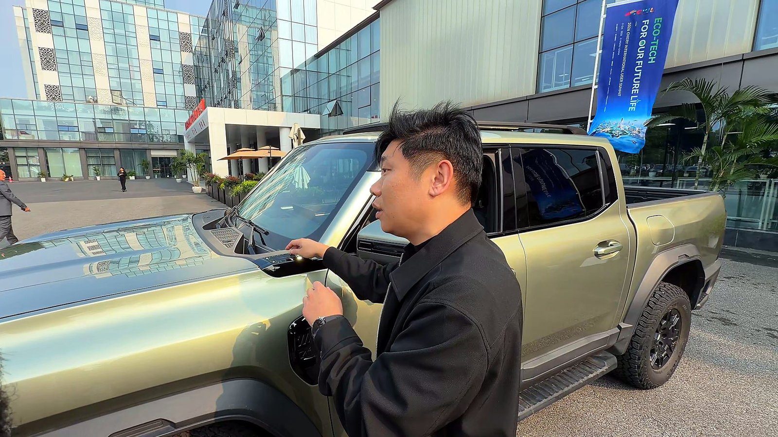 Mark Qi showing an accessory mount at the base of the Stockman A-pillar