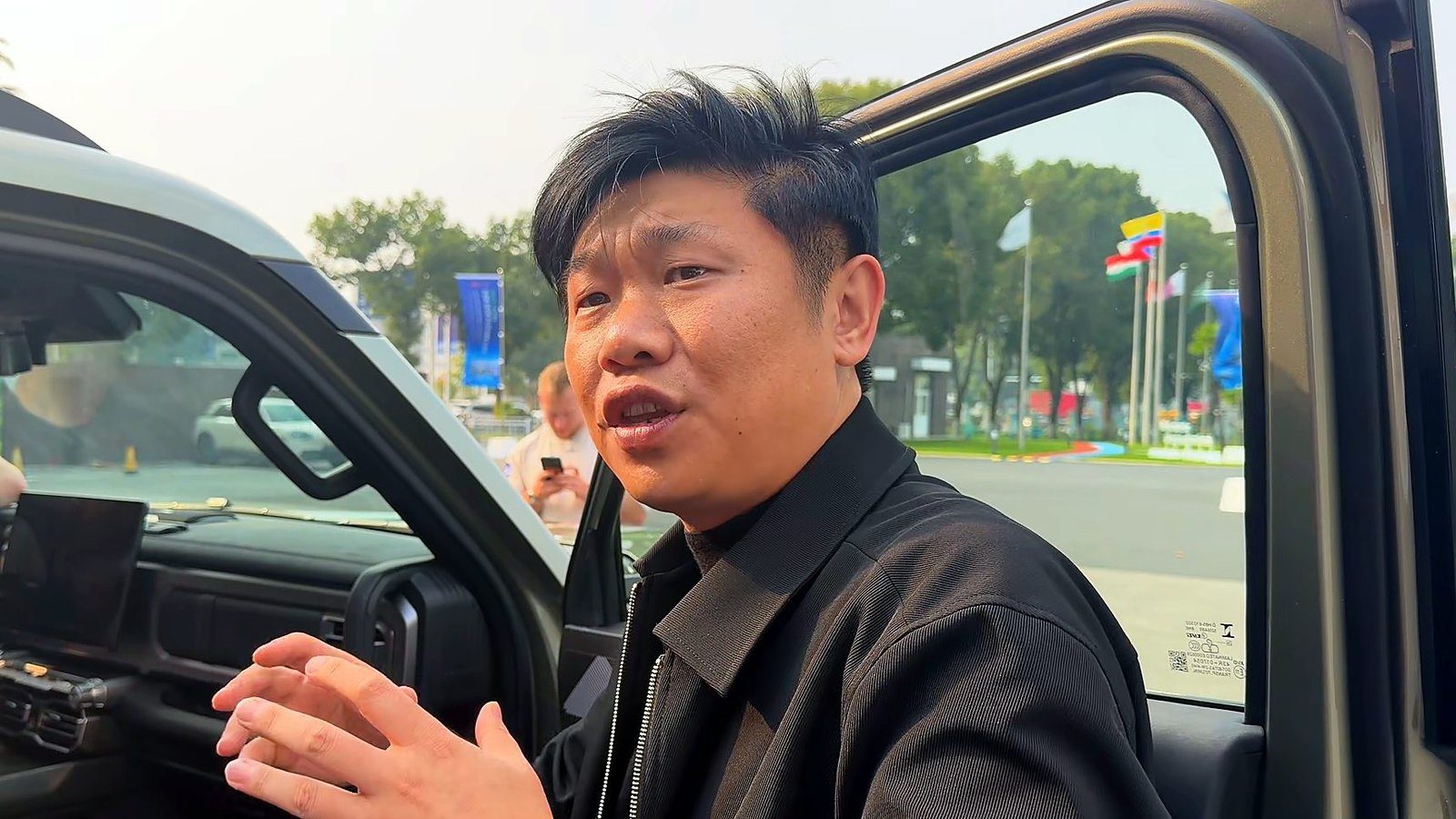 Chery Stockman chief engineer Mark Qi talking beside the ute