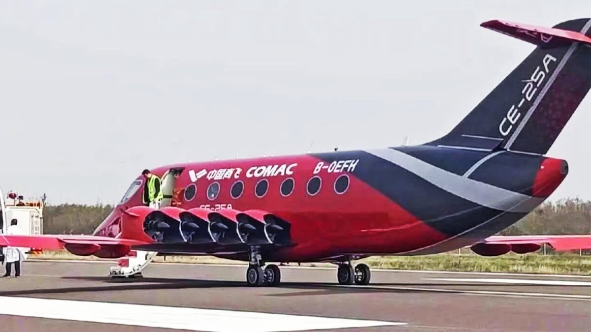 Red and black COMAC CE-25A electric aircraft showing its wing-mounted ducted fans, registration B-0EFH