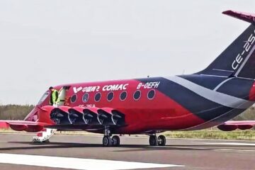 Red and black COMAC CE-25A electric aircraft showing its wing-mounted ducted fans, registration B-0EFH