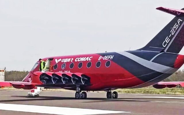 Red and black COMAC CE-25A electric aircraft showing its wing-mounted ducted fans, registration B-0EFH