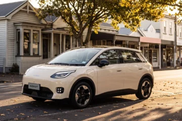 White GAC Aion UT parked on a small-town main street