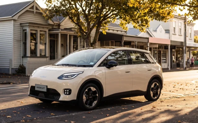White GAC Aion UT parked on a small-town main street