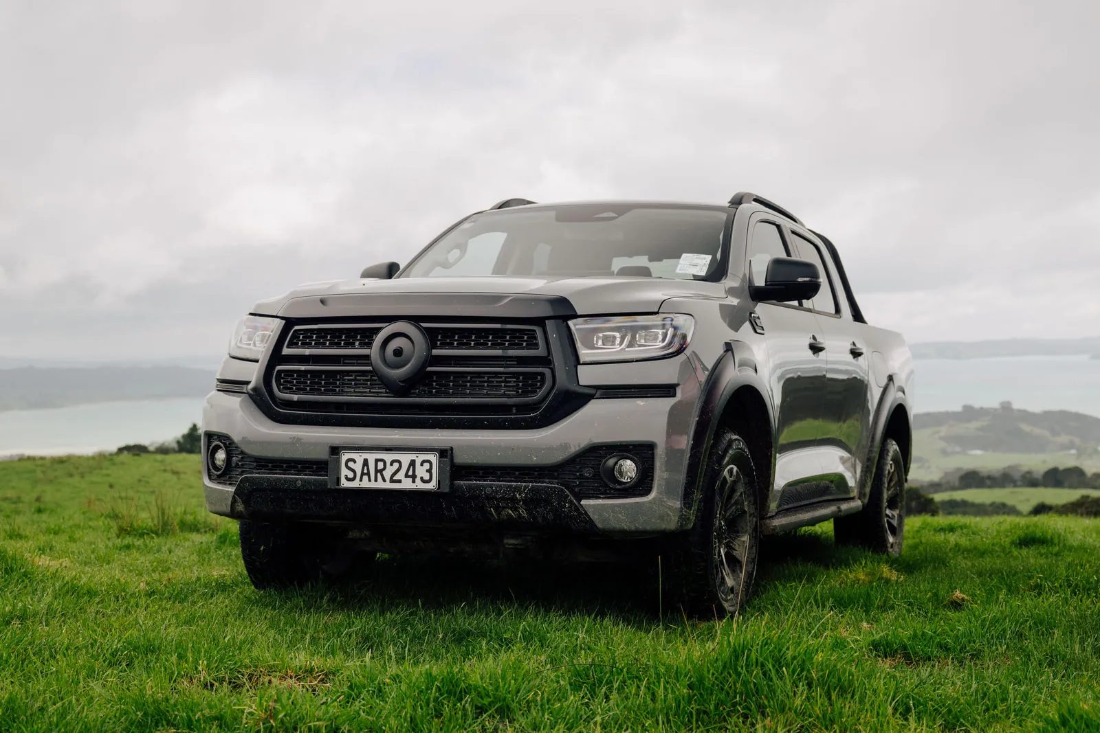 Front of a grey GWM Cannon Hi4-T PHEV showing the grille and LED headlights
