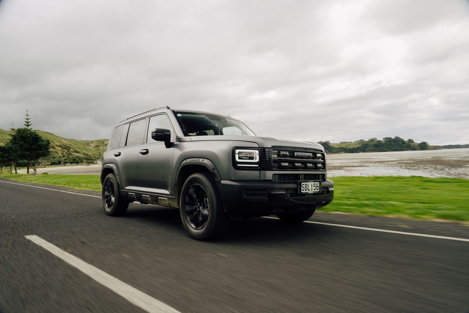 Matte grey Haval H7 parked on a coastal road