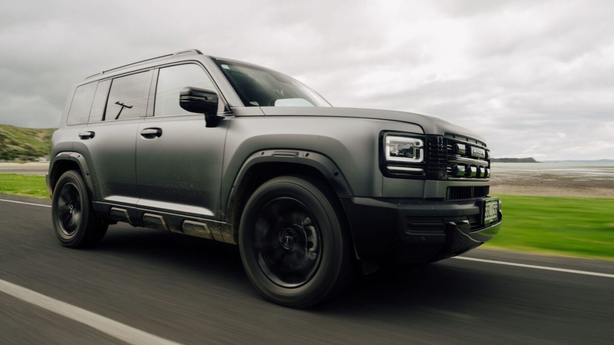Matte grey Haval H7 PHEV driving on a coastal road