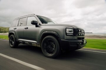Matte grey Haval H7 PHEV driving on a coastal road