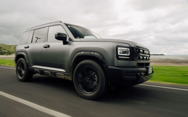 Matte grey Haval H7 PHEV driving on a coastal road