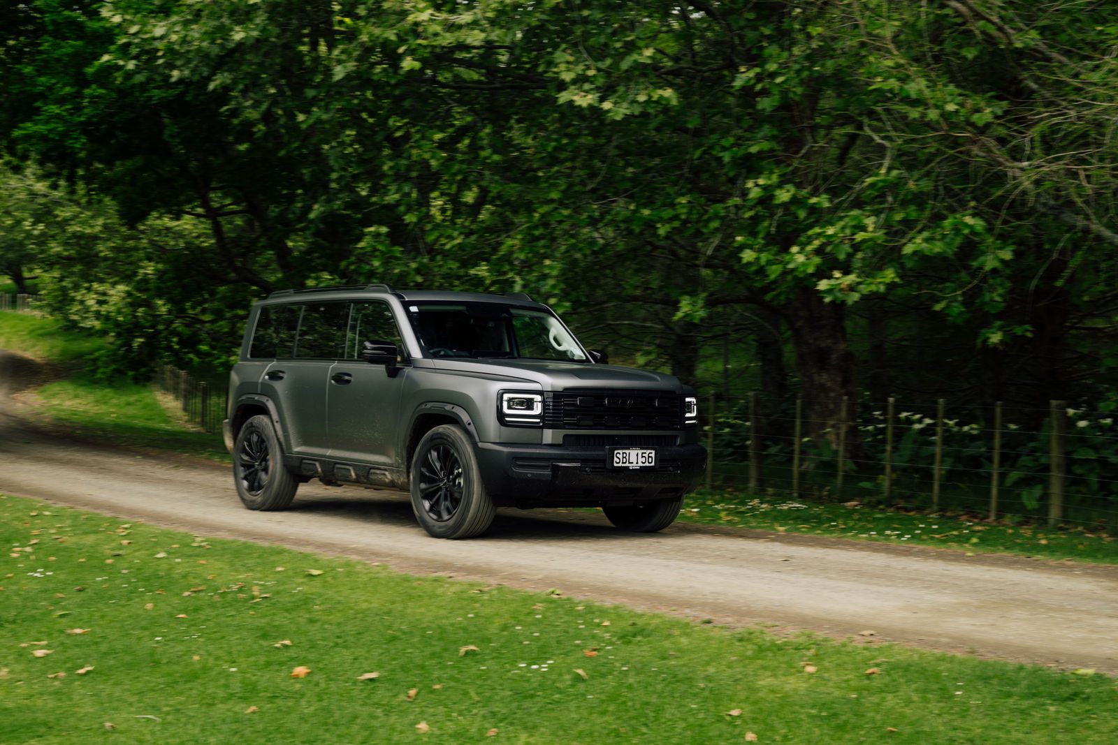 Matte grey Haval H7 on a tree-lined gravel drive