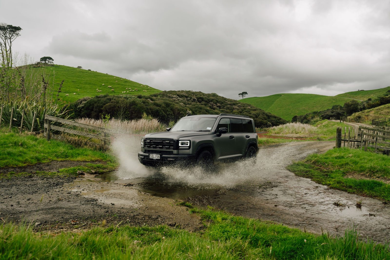Haval H7 splashing through a water crossing on a farm track