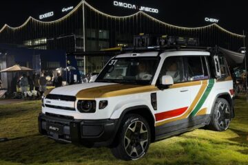 White iCAUR V27 with roof boxes and awning outside Chery headquarters in Wuhu