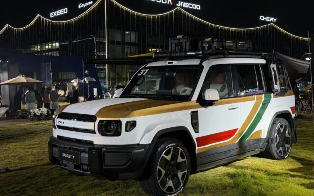 White iCAUR V27 with roof boxes and awning outside Chery headquarters in Wuhu