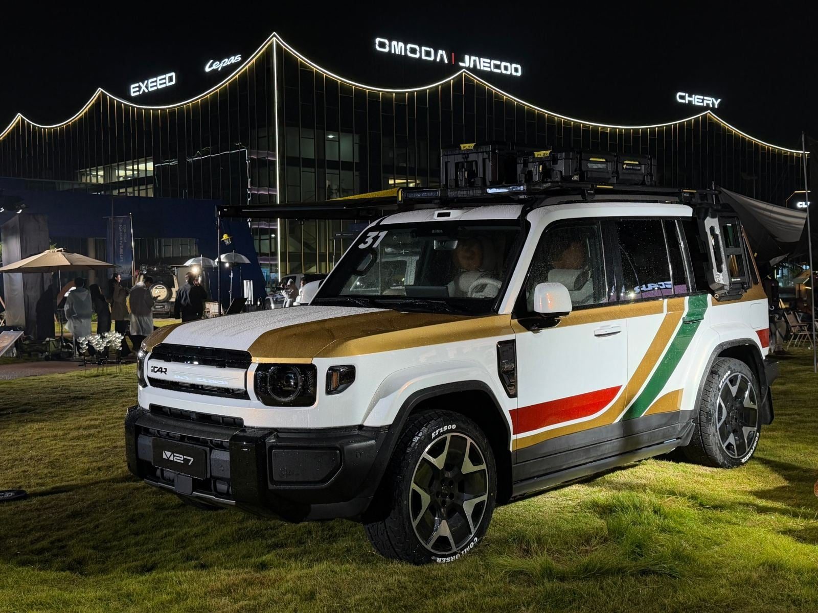 White iCAUR V27 with roof boxes and awning outside Chery headquarters in Wuhu