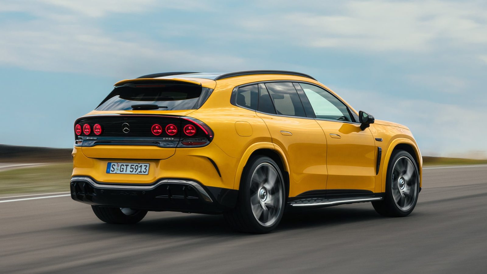 Rear three-quarter view of the yellow Mercedes-AMG GT SUV