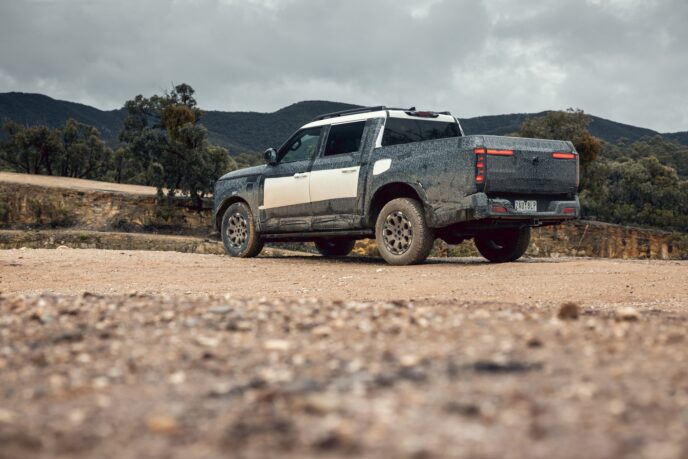 Nissan Navara Pro PHEV prototype rear three-quarter view on gravel