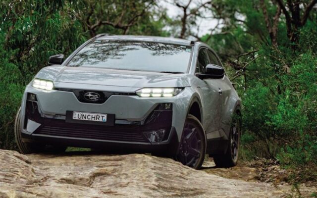 Grey Subaru Uncharted electric SUV climbing a rocky track through bush