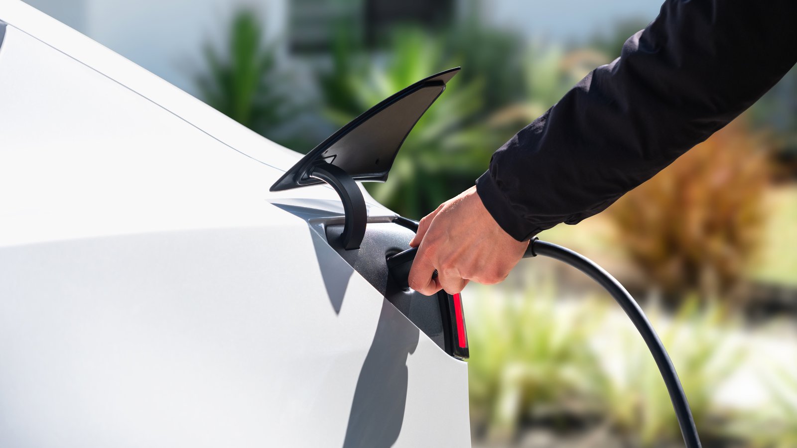Charging cable being plugged into a Tesla Model 3