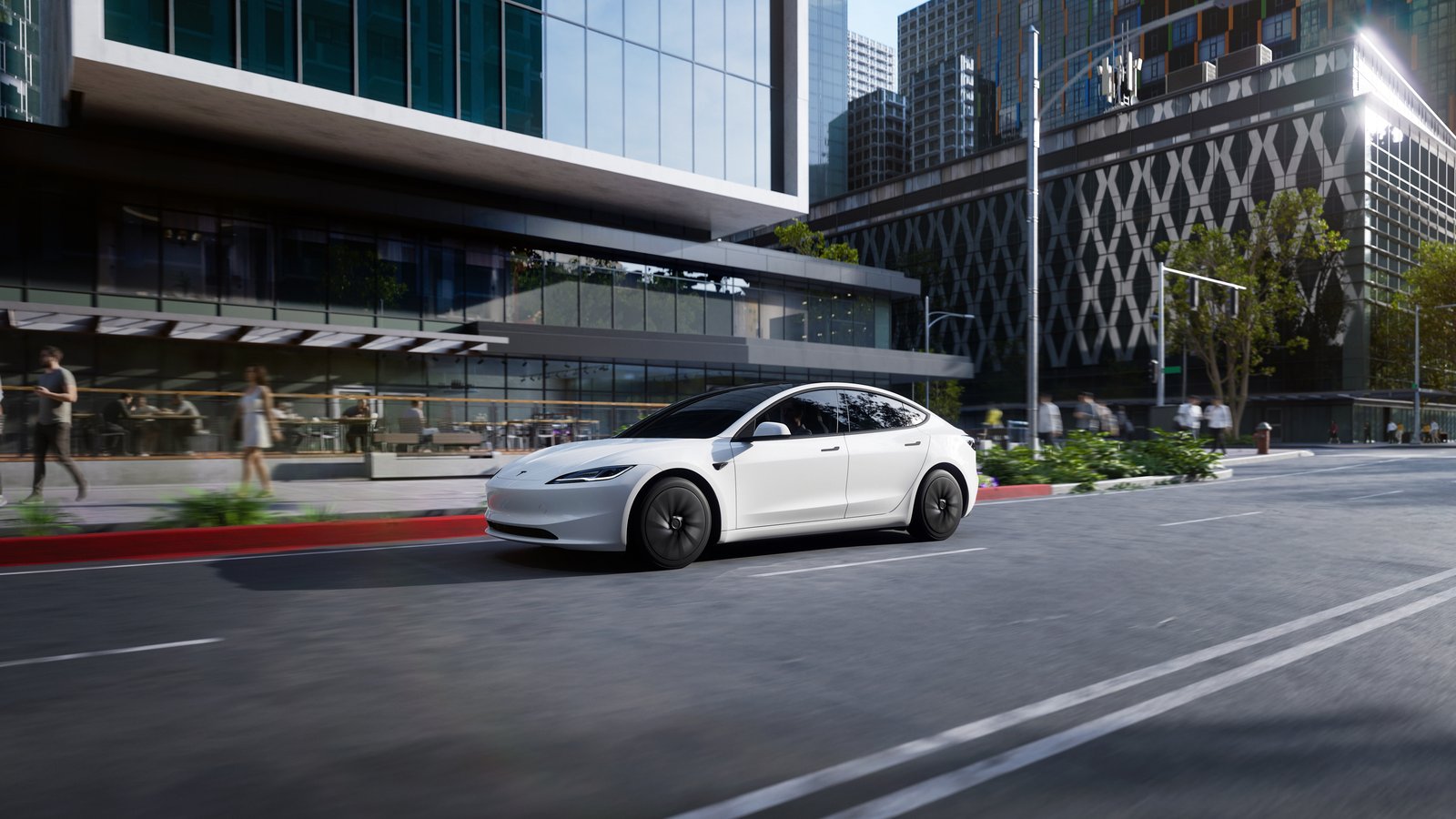 White Tesla Model 3 driving through a city