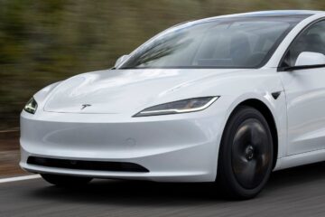 White Tesla Model 3 driving on a country road