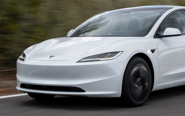 White Tesla Model 3 driving on a country road