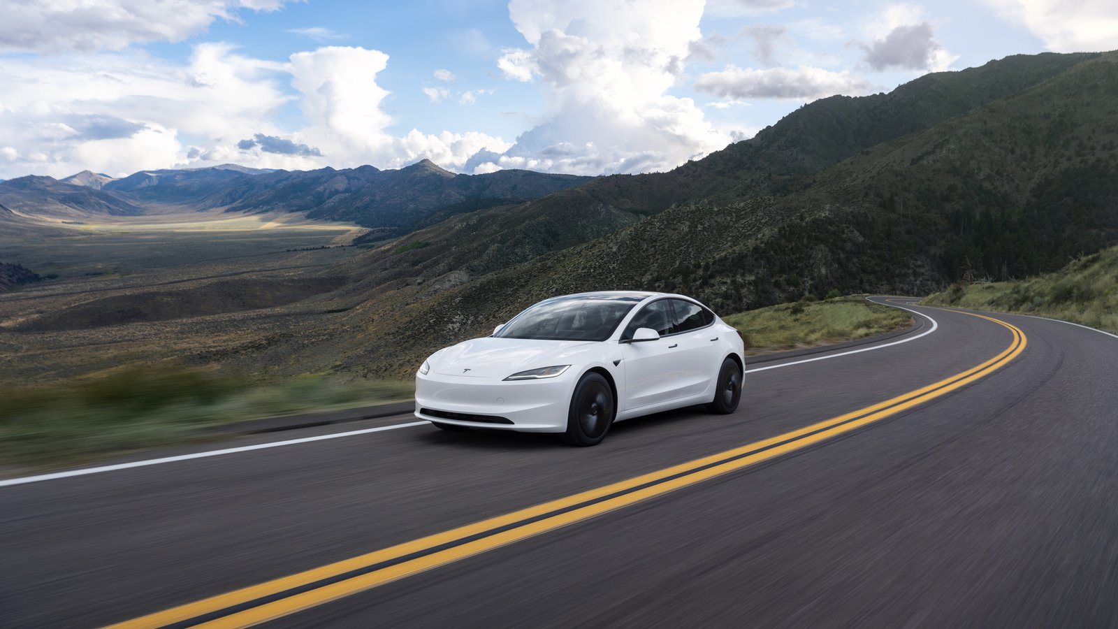 White Tesla Model 3 on a winding mountain road