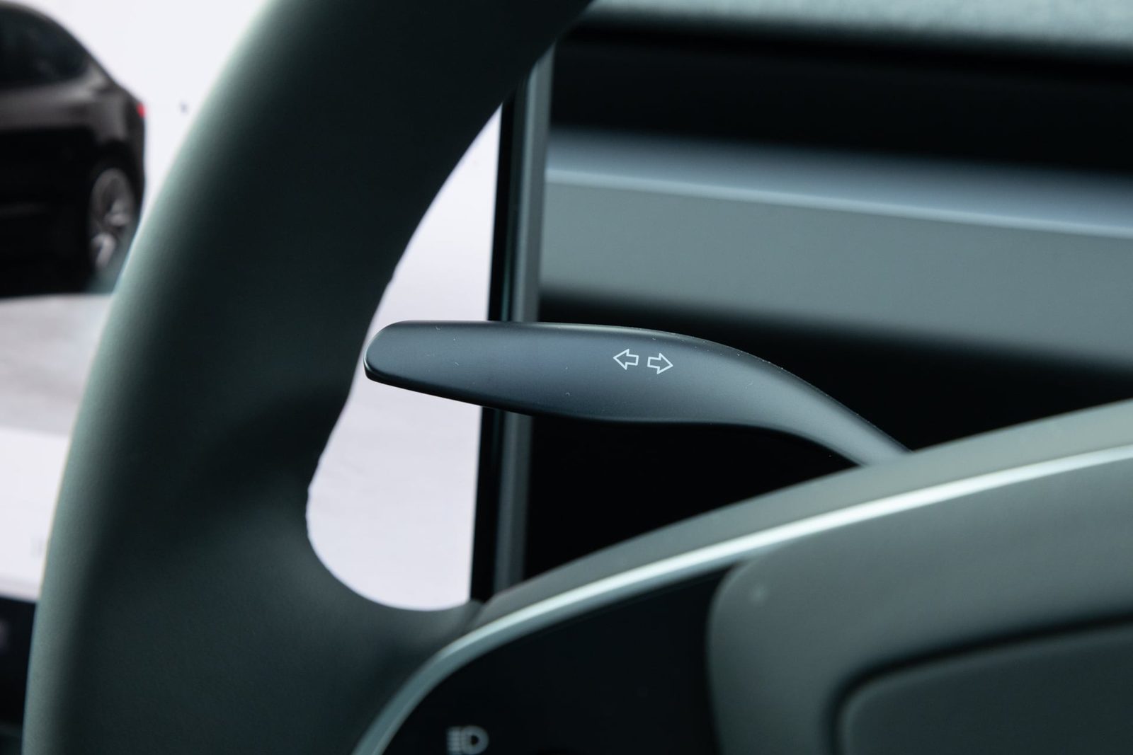 Indicator stalk behind the Tesla Model 3 steering wheel