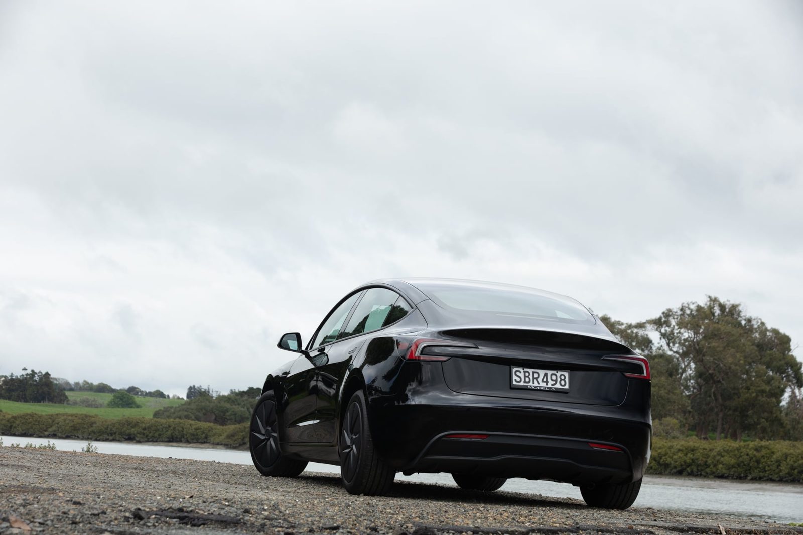 Rear three-quarter view of the black Tesla Model 3 Rear-Wheel Drive