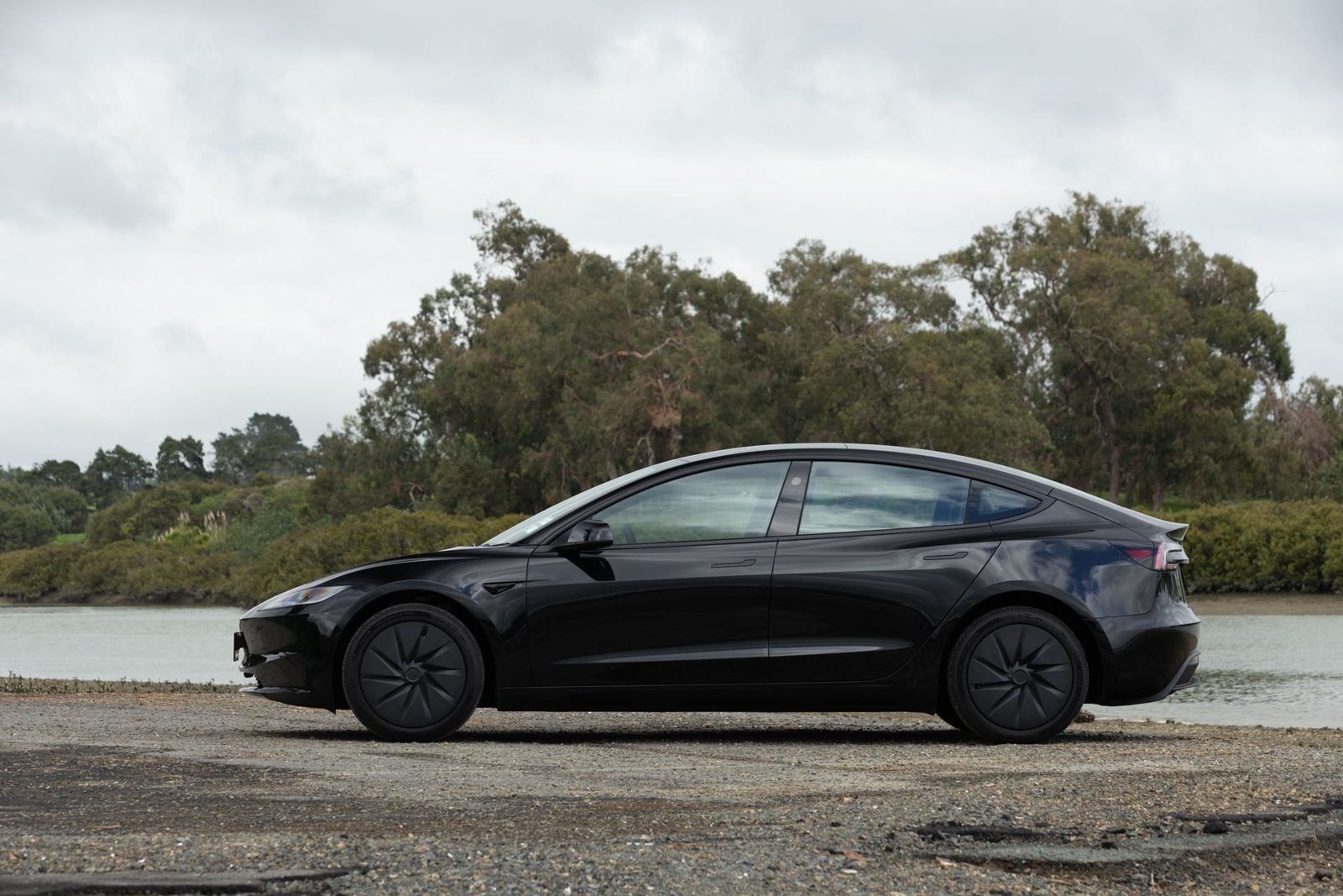 Side profile of the black Tesla Model 3 Rear-Wheel Drive