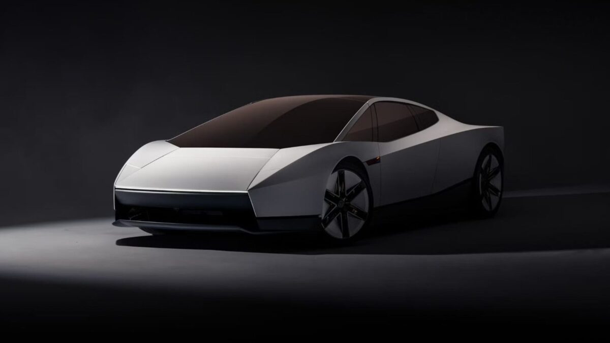 White second-generation Tesla Roadster front three-quarter view in a dark studio