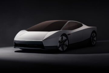 White second-generation Tesla Roadster front three-quarter view in a dark studio